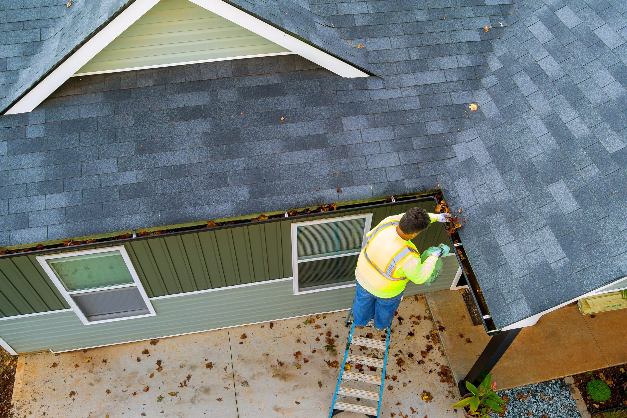 Worker Cleaning Clogged Roof Gutter Drain – Expert Gutter Cleaning in Trenton, TN