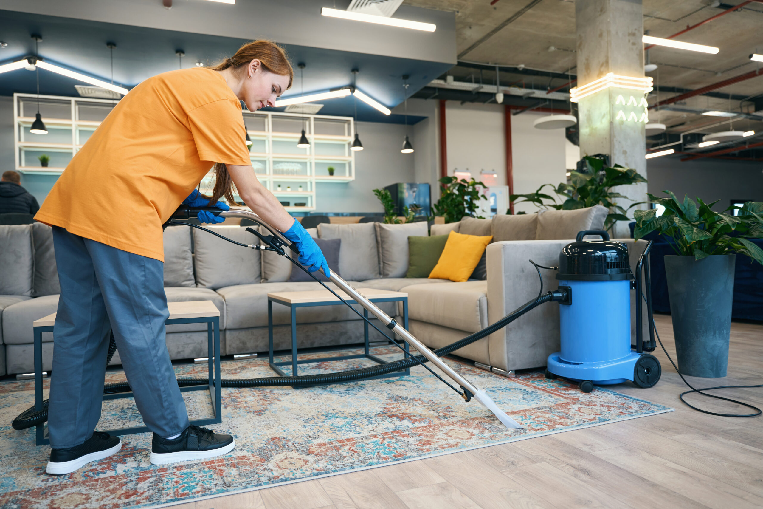 Carpet Cleaning Services Prosper TX Carpet Cleaning Services McKinney TX Woman from cleaning company in comfortable uniform cleans the carpet