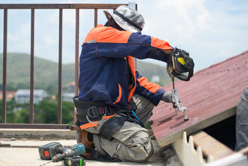 Roof Maintenance Services Lynn Haven FL Professional engineer worker installing solar panels system on rooftop