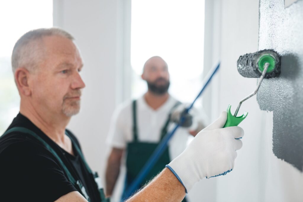 Your 2025 Guide to Expert Drywall and Painting Panama City FL Renovation crew of three professional builders remodeling bright apartment